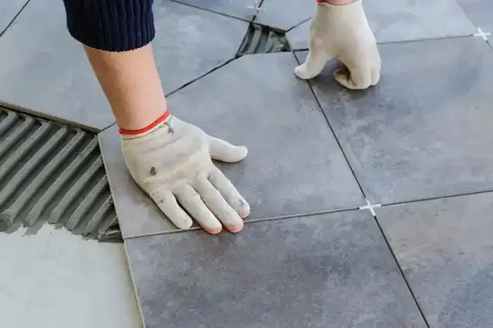 Professional cleaning tiled wall before grout sealing and tile restoration
